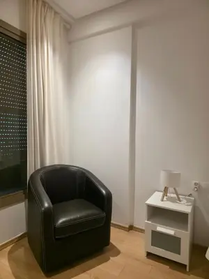 a black chair sitting in a room with a table at super studio in Aïn Harrouda