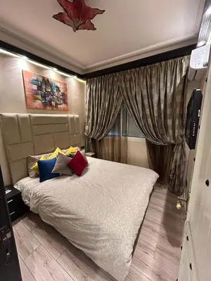 a bedroom with a large bed and a window at Grand appartement romandie in Casablanca