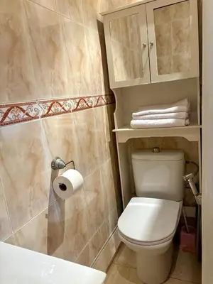 a bathroom with a toilet and a sink and a toilet paper roll at Appartement en plein cœur de Agdal in Rabat