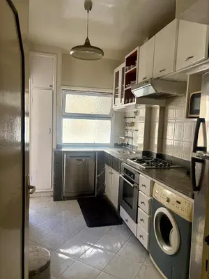 a kitchen with a stove and a dishwasher at Appartement en plein cœur de Agdal in Rabat