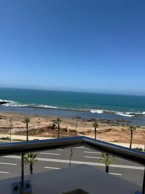 a view of the ocean from the balcony of a beach at Appartement vue sur mer 3 chambres in Rabat