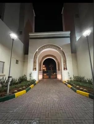 an entrance to a building with an arch at night at Appartement vue sur mer 3 chambres in Rabat