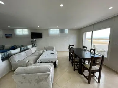 a living room with a couch and a table at Maison Bord de Mer Skhirate in Skhirat