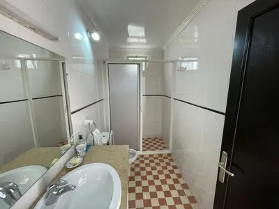 a bathroom with a sink and a toilet and a mirror at Maison Bord de Mer Skhirate in Skhirat