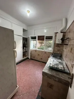 an empty kitchen with a counter and a refrigerator at Villa Val d'Or in Temara