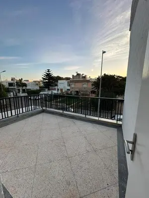 a balcony with a fence and a building at Villa Val d'Or in Temara