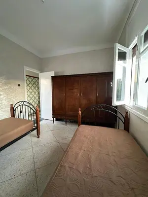 a bedroom with two beds and a large window at Villa Val d'Or in Temara