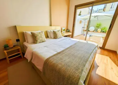 a bedroom with a large bed and a large window at Maya Suites - Oasis Casablanca in Casablanca