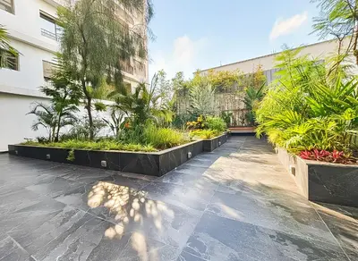 a courtyard with plants and a building at Maya Suites - Oasis Casablanca in Casablanca