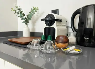 a counter top with a coffee maker and cups on it at Maya Suites - Oasis Casablanca in Casablanca