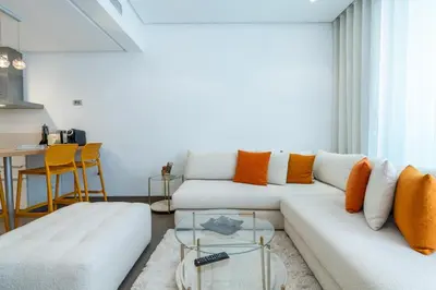a living room with a white couch and orange pillows at C08- Anfa Place Luxury Apartment - Beach Access in Casablanca