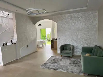 a living room with two chairs and a couch at Villa moderne en bord de mer in Skhirat