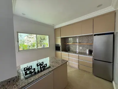 a kitchen with a stainless steel refrigerator and a window at Villa moderne en bord de mer in Skhirat