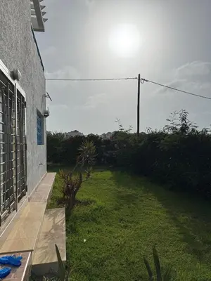 a view of a yard with a house at Villa moderne en bord de mer in Skhirat
