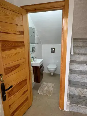 a bathroom with a toilet and a sink at Villa moderne en bord de mer in Skhirat