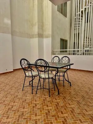 four chairs around a table in a room at Appartement Typique Marocain in Oulad Akkou