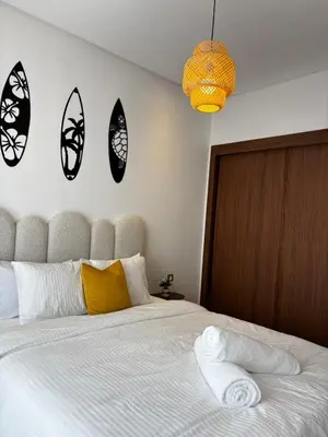 a bedroom with a large white bed with four mirrors on the wall at Cozy & Chill à 30min terrain de foot Netflix, AC pool & beach 2 min, in Bouznika