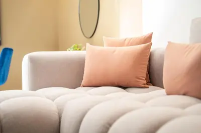 a couch with pillows on it in a living room at C13 - 1BR Suite - Private Gym - Terrace - Rooftop in Maarif