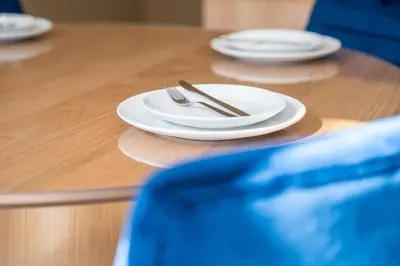 a table with white plates and silverware on it at C13 - 1BR Suite - Private Gym - Terrace - Rooftop in Maarif