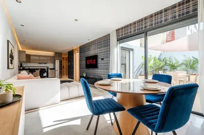 a dining room with a table and blue chairs at C13 - 1BR Suite - Private Gym - Terrace - Rooftop in Maarif