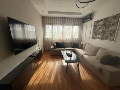 a living room with a couch and a tv at Marina, Medina et Bab Marrakech 8 min Hassan 2 in Casablanca