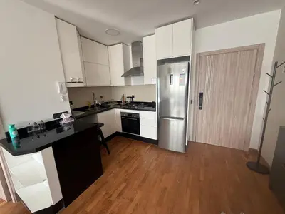 a kitchen with white cabinets and a stainless steel refrigerator at Marina, Medina et Bab Marrakech 8 min Hassan 2 in Casablanca