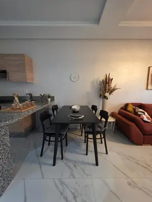 a living room with a black table and chairs at Appartement in Casablanca