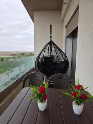 a wooden table with two potted plants on a balcony at Appartement in Casablanca