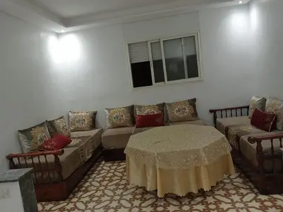 a living room with a couch and a table at Appartement temara in Temara