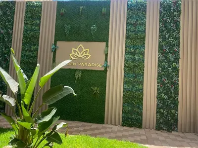 a green wall with a sign on it at New ground floor apartment - Large terrace direct access to pool in Bouznika