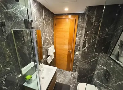 a bathroom with a sink and a glass shower at Maya Suites - Riviera B Casablanca in Casablanca