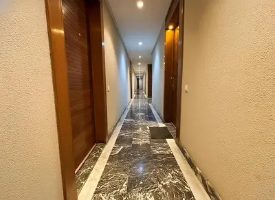 a corridor of a hotel with marble floors and walls at Maya Suites - Riviera B Casablanca in Casablanca