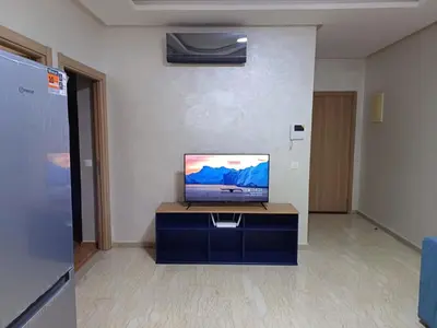 a living room with a tv on a table at Apartment kamal park F1 in Mohammedia