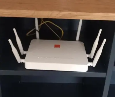 a white laptop sitting on a shelf with sticks at Apartment kamal park F1 in Mohammedia