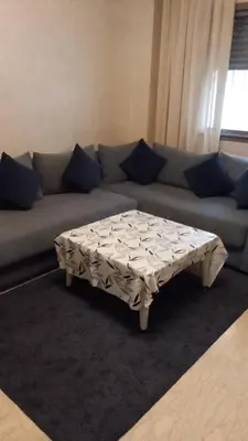 a living room with a couch with a coffee table at Apartment kamal park F1 in Mohammedia