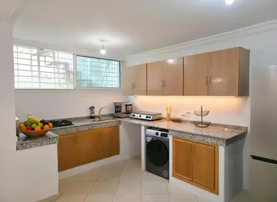 a kitchen with a sink and a dishwasher at Beach & Art Bungalow in El Harhoura