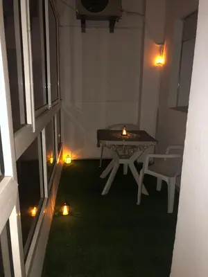 a room with a table and lights on the grass at Central Casablanca Apartment Steps from Hassan II Area in Casablanca