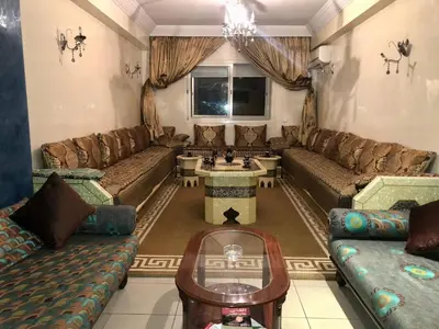 a living room with couches and a table at Central Casablanca Apartment Steps from Hassan II Area in Casablanca