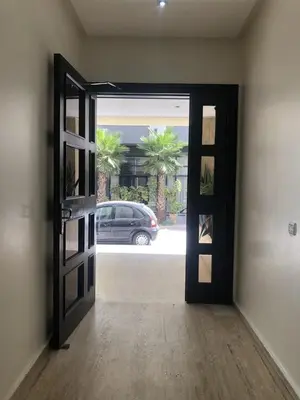 an open door to a garage with a car outside at Central Casablanca Apartment Steps from Hassan II Area in Casablanca