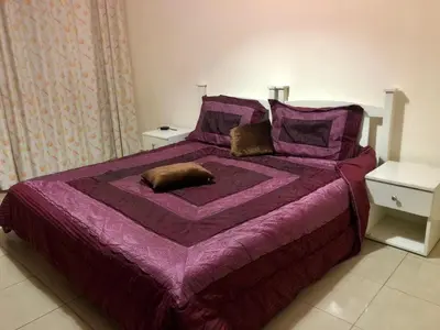 a bedroom with a purple bed with two pillows at Central Casablanca Apartment Steps from Hassan II Area in Casablanca