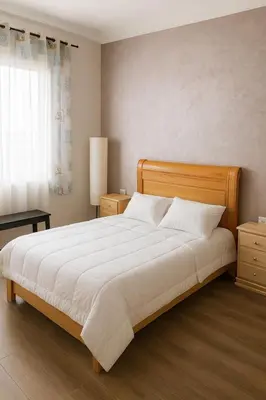 a bedroom with a large bed and a window at Spacieux RDC avec salle de sport privative in Bouznika