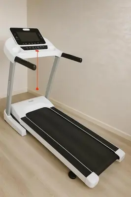 a treadmill with a cell phone on top of it at Spacieux RDC avec salle de sport privative in Bouznika