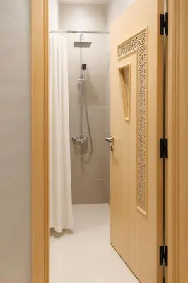 a bathroom with a shower with a shower curtain at Spacieux RDC avec salle de sport privative in Bouznika