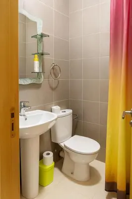 a bathroom with a toilet and a sink at Spacieux RDC avec salle de sport privative in Bouznika