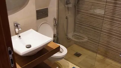 a bathroom with a sink and a toilet and a shower at Modern Studio with Rooftop Pool & Free Parking in Casablanca