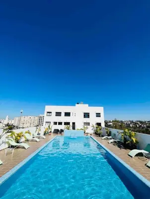 a swimming pool on the roof of a building at Modern Studio with Rooftop Pool & Free Parking in Casablanca