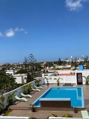 a swimming pool on the roof of a house at Modern Studio with Rooftop Pool & Free Parking in Casablanca