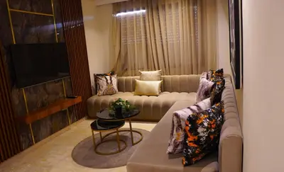 a living room with a couch and a television at Modern Studio with Rooftop Pool & Free Parking in Casablanca