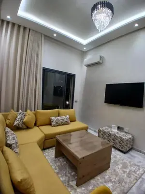 a living room with a yellow couch and a tv at Appartement 3 chambres avec piscine, proche de la plage Zenâta Eco City in Aïn Harrouda