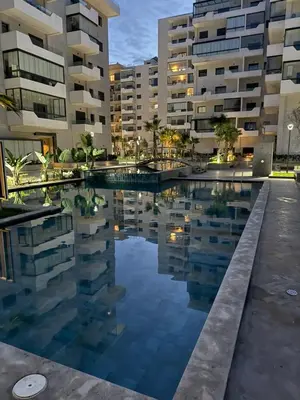 a swimming pool in front of some buildings at Appartement 3 chambres avec piscine, proche de la plage Zenâta Eco City in Aïn Harrouda